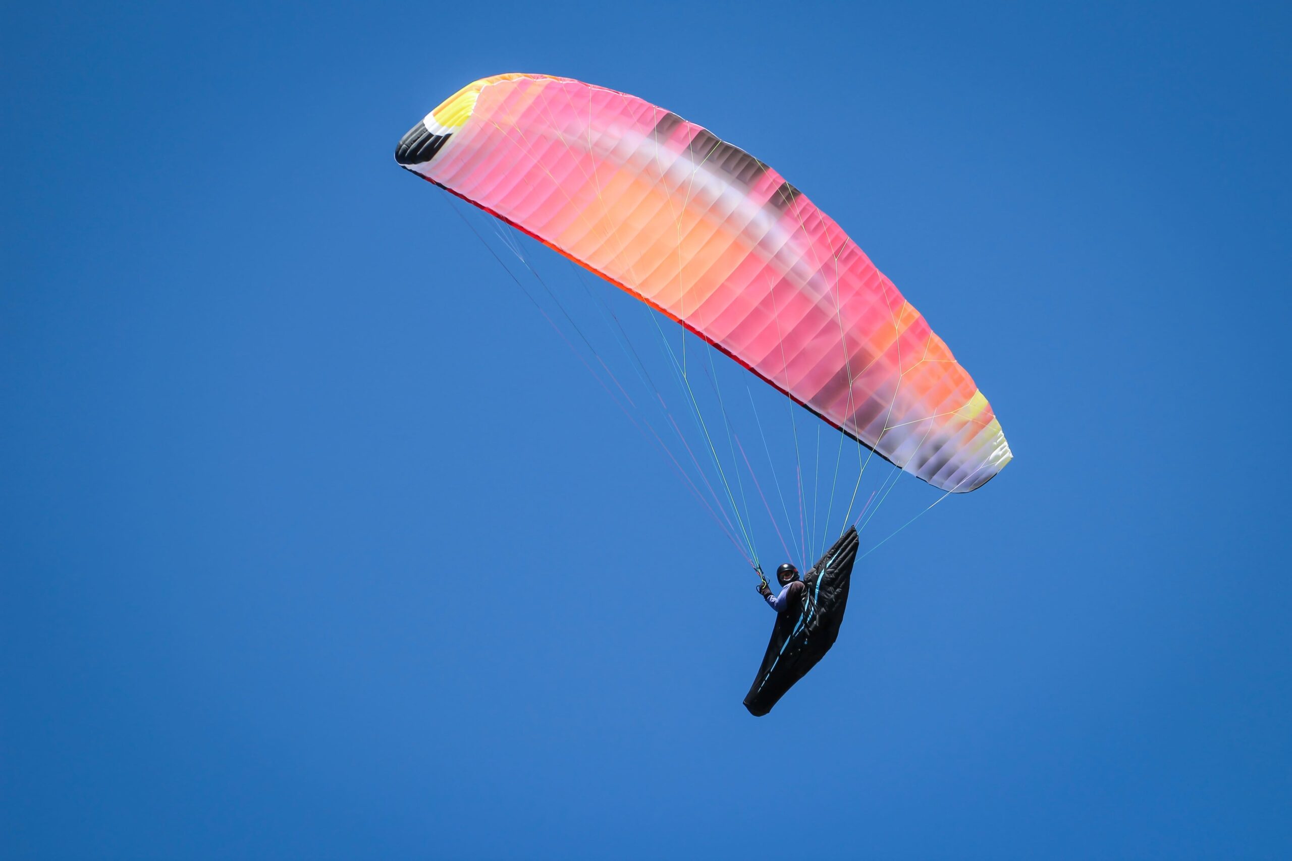 Your Sky Adventure Starts Here - Bir Billing Paragliding low angle shot person paragliding sunny day bright sky