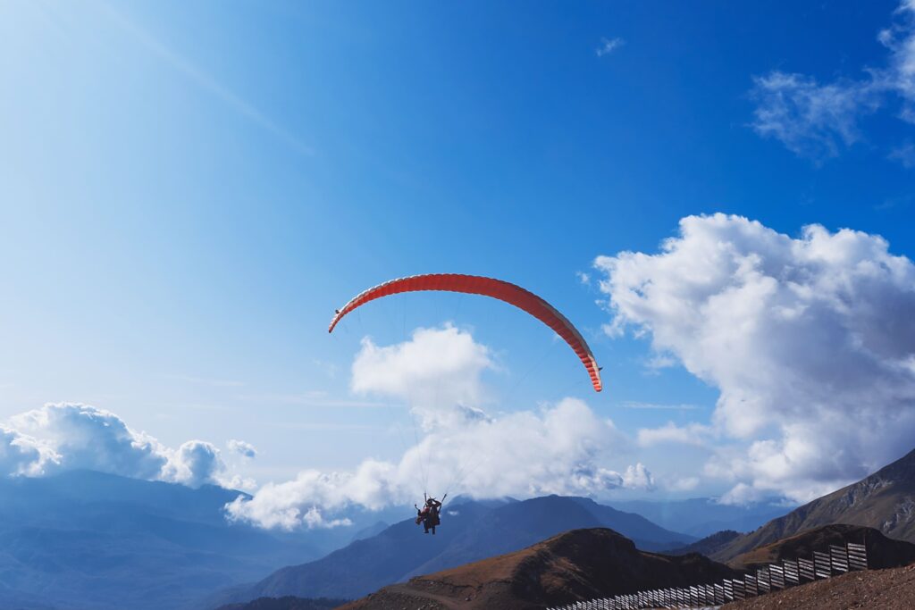 paraglider flying mountains bright summer day paragliding sport concept